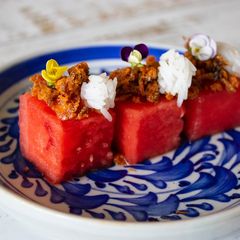 A picture of Pla Hang Tang Mo. Watermelon with sweet and salty salmon flakes.