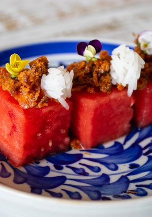 A picture of Pla Hang Tang Mo. Watermelon with sweet and salty salmon flakes.