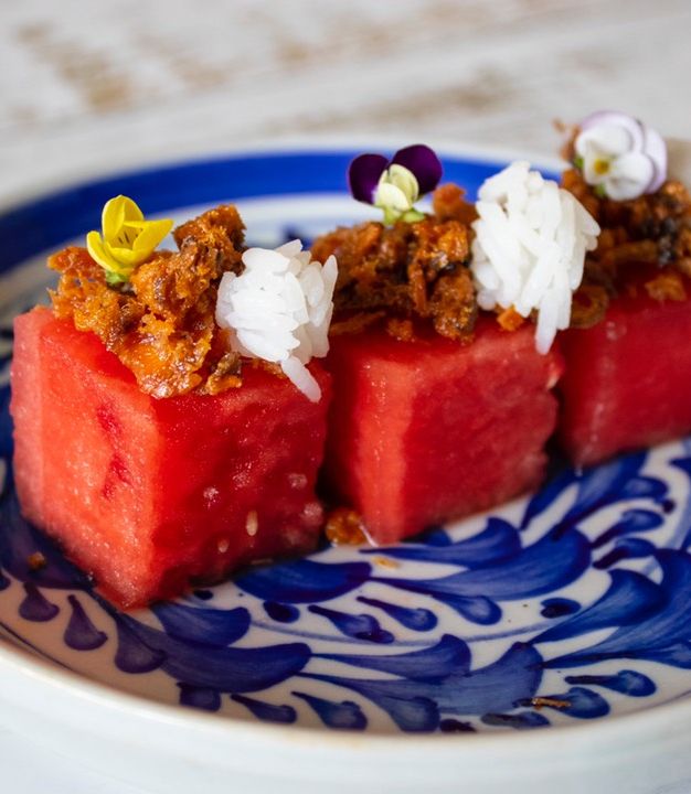 A picture of Pla Hang Tang Mo. Watermelon with sweet and salty salmon flakes.