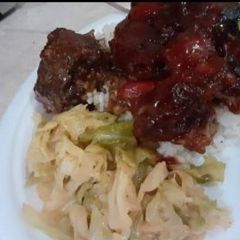 A picture of Bbq oxtails w rice in cabbage.