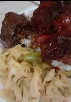 A picture of Bbq oxtails w rice in cabbage.