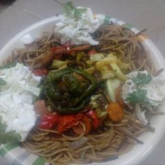 A picture of Onionspa with vegetable sauce and coslaw.