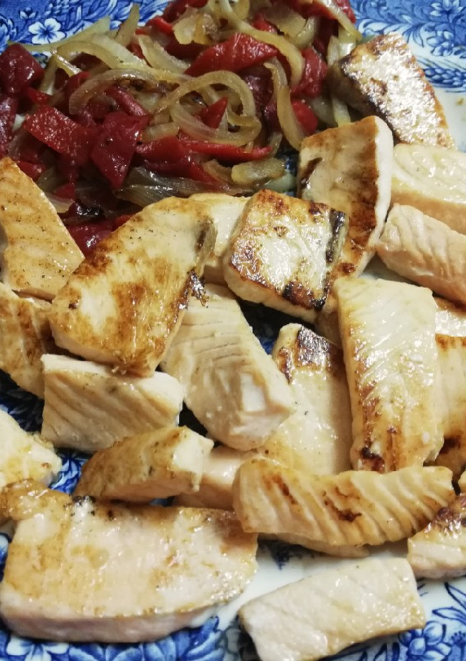 Una foto de Taquitos de salmón a la plancha con cebolla y pimientos