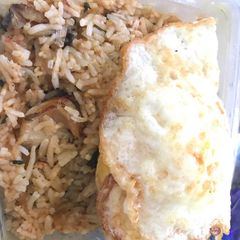 A picture of Concoction Rice and fried egg.
