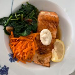 A picture of Salmon with tartar sauce.