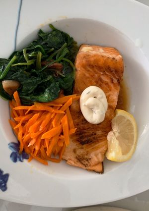 A picture of Salmon with tartar sauce.
