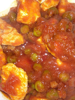 Una foto de Pechuga de pavo con guisantes y tomate