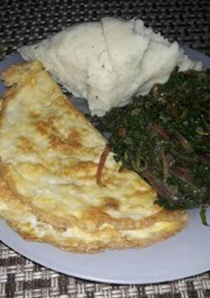 A picture of Omelette, sauted kales with Ugali.