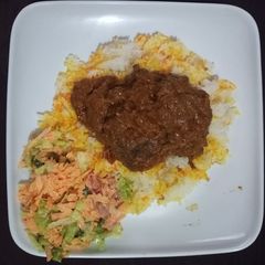 A picture of Chicken biriani with salad.