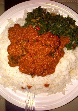 A picture of Stew and vegetable sauce with rice.
