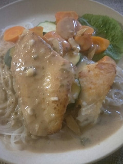 A picture of Pan fried fish fillet with green curry sauce.