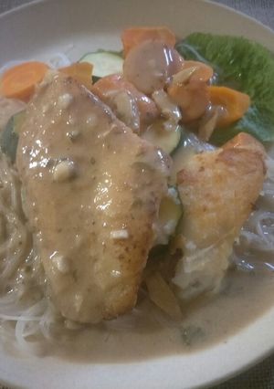A picture of Pan fried fish fillet with green curry sauce.