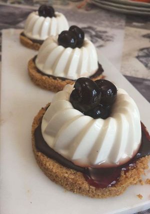 A picture of Panna Cotta with Chocolate and Cherries.