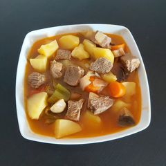 A picture of Beef stew with potatoes and veggies.