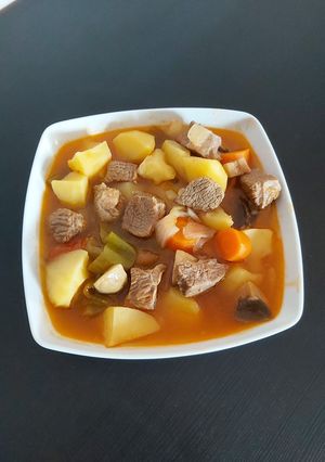 A picture of Beef stew with potatoes and veggies.
