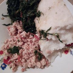 A picture of Fried eggs with greens and ugali.