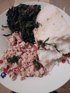 A picture of Fried eggs with greens and ugali.