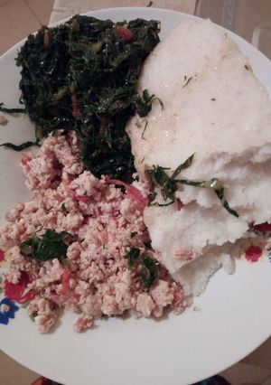 A picture of Fried eggs with greens and ugali.