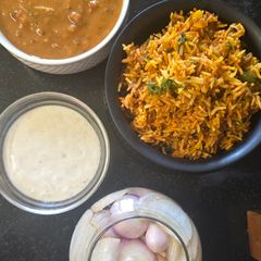 A picture of Biryani dal makhani raita platter.