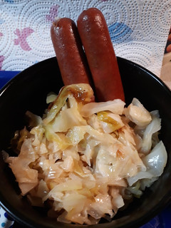 A picture of Salted Fried Cabbage and Steamdogs.