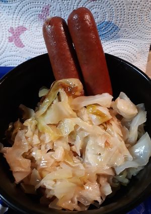 A picture of Salted Fried Cabbage and Steamdogs.