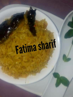 A picture of Jallof rice with smoke fish.