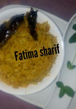 A picture of Jallof rice with smoke fish.