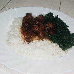A picture of Gizzard with rice and greens.