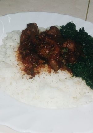 A picture of Gizzard with rice and greens.