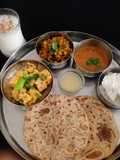 Gujarati Thali For lunch or dinner (puran poli khandvi,dana muthiya sabji,rice,dal)