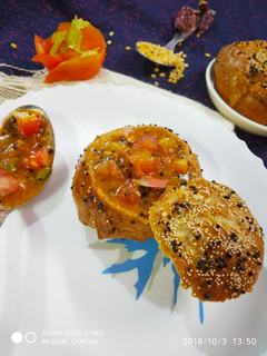 A picture of Pretzel bread buns filled tomato kootu.