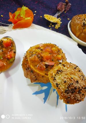 A picture of Pretzel bread buns filled tomato kootu.