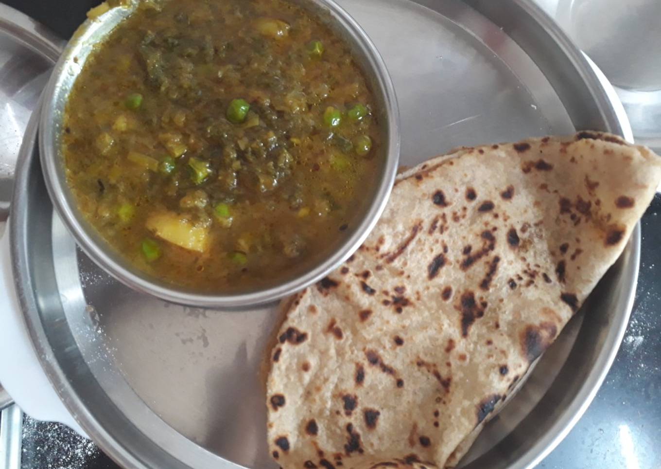 Green onion leaves, peas and potato curry