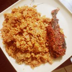A picture of Spicy jollof rice & peppered fish.
