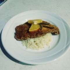 A picture of Fried cajun mangove snapper with citrus garlic butter rice.