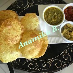 A picture of Maha Ashtami Sandhi Puja Thali: Luchi, Cholar Dal, Tomato Chutney & Kesari Halwa.