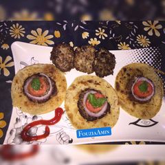 A picture of Coin Chapli kabab with Coin Paratha.