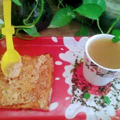 Green tea with brown bread peanuts butter A picture of Green tea with brown bread peanuts butter.