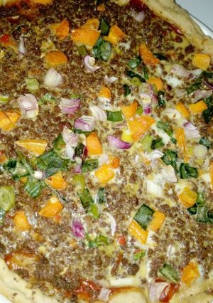 A picture of Cheeseless colourful pizza.
