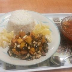 A picture of Rice with stew and plantain.