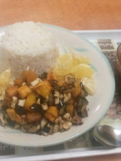 A picture of Rice with stew and plantain.