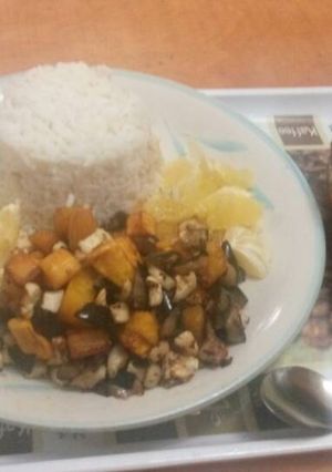 A picture of Rice with stew and plantain.