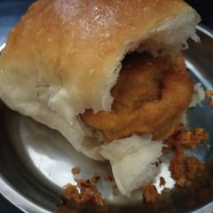 A picture of Vada pav with dry chutney.