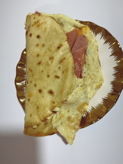 A picture of Tortilla and egg sausage wrap.