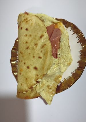 A picture of Tortilla and egg sausage wrap.