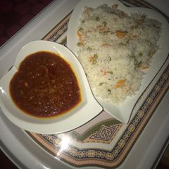 A picture of Carrot and green beans rice with stew.