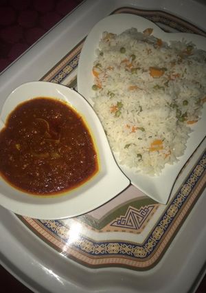 A picture of Carrot and green beans rice with stew.