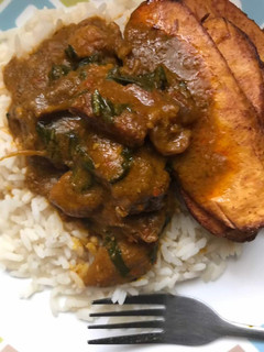 A picture of Banga Stew with White Rice and Plantain.