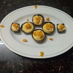 A picture of Mango mousse with choco cup.
