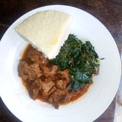 A picture of Beef stew Ugali and Cowpeasleaves.